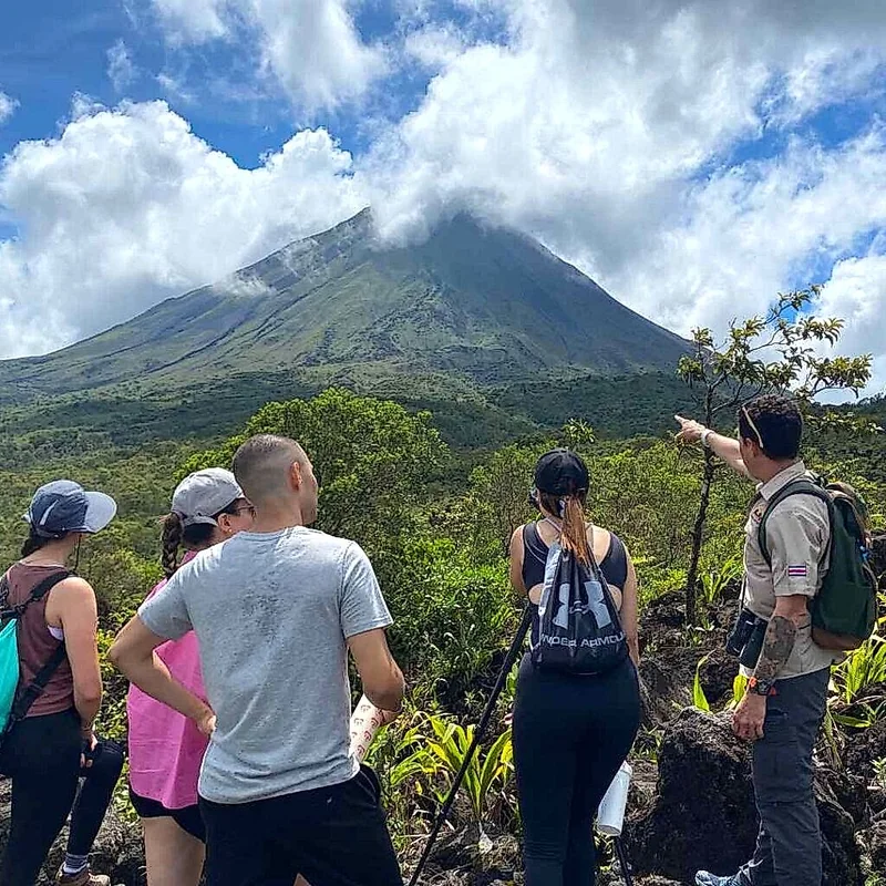 Guided hike through the volcanic lava trails with the majestic Arenal in the background.